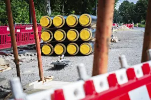 Dusseldorf Construction Site Prints: A stack of district heating pipes on a construction site in Dusseldorf