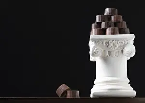 Diverse Dessert Options Prints: Stack of fine artisan chocolates stacked on white pillar column