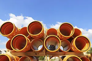 Environmental Pollution Europe Prints: Stack of KG pipes on a construction site in the Mutterstadt development area