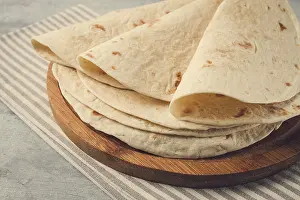 High Angle Shot Of Meal Prints: A stack of Mexican tortillas, on a gray table