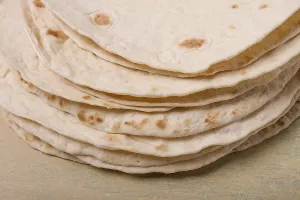 Deserted Table Setup Prints: A stack of Mexican tortillas, on a gray table