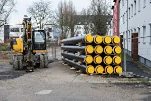 Construction Site Düsseldorf Prints: A stack of new district heating pipes on a construction site in Dusseldorf