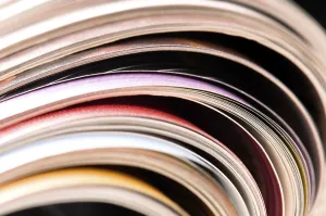 Environmental Conservation Through Reuse Prints: Stack of open magazines