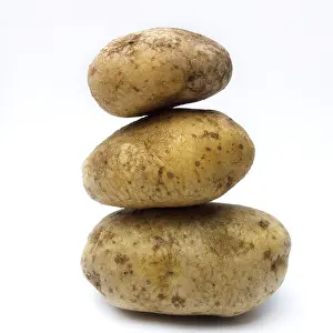Grocery Items Prints: A stack of organic potatoes on white background