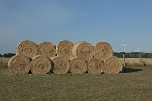 Sustainable Energy Supply Prints: Stack of round bales, straw, wind turbines