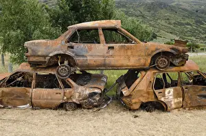 Deserted Junkyard Scene Prints: Stack of three rusty car wrecks