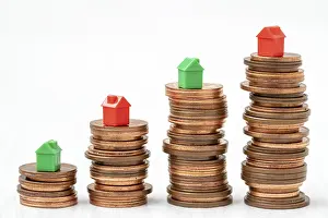 Deserted Homes Prints: Stacked coins with mini houses on the top