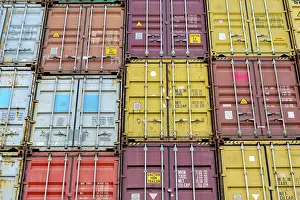 Container Terminal Prints: Standard shipping container in a container terminal in front of loading onto a container ship
