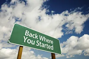 Dramatic Clouds Prints: Back where you started road sign with dramatic clouds and sky