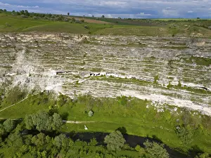 Prints of Steep cliffs with lush vegetation and a river course at the base in a green setting, aerial view, cave dwellings, Răut River, Raut, Old Orhei, Orheiul Vechi, archaeological site Moldova Prints: Aerial View of Steep Cliffs Print, Republic of Moldova
