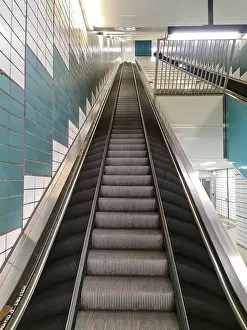 Deserted Subway Station Prints: Empty steps of an escalator in a perspective view