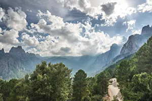 Rural Road Photography Prints: Street through a valley with cliffs in clouds