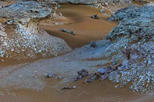 Deserted Omani Landscapes Prints: Striking cliffs surrounded by windswept sand structures