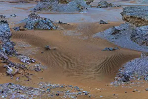 Omani Travel Photography Prints: Striking cliffs surrounded by windswept sand structures