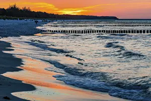 Deserted Beach Evening Sun Prints: Strollers and groynes at the beach of Zingst at sunset
