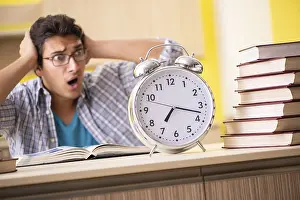 Student Studying At Home Prints: Student preparing for exam sitting at the kitchen
