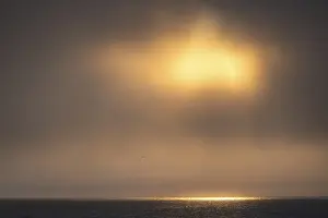 Svalbard Norway Prints: Sun breaking through clouds, reflection on sea surface