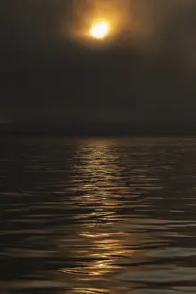 Svalbard Norway Prints: Sun breaking through clouds, reflection on slightly wavy sea surface