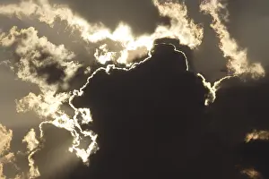 Cloudy Atmosphere Prints: Sun behind dark storm clouds