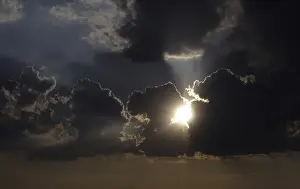 Cloudy Atmosphere Prints: Sun behind storm clouds