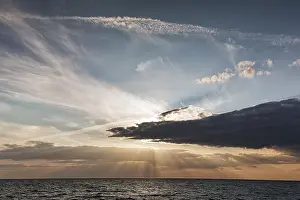 Evening Sun On The Sea Prints: Sunbeams behind clouds, dramatic evening sky