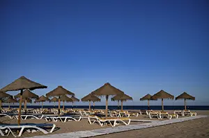 Deserted Sunbeds Prints: Sunbeds, empty, raffia parasols