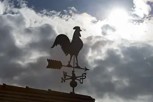 Dramatic Cloud Formations Europe Prints: Sunlit weather vane in front of dramatic cloud formations
