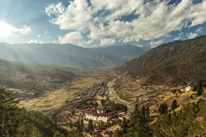 Cloudy Sunset Prints: Sunrays through the clouds as the sun is setting over Paro