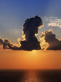 Santorini Sunset Prints: Sunset behind clouds at the sea