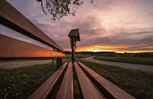 Central Europe Evening Sky Prints: Sunset at a memorial and a bench in front of it