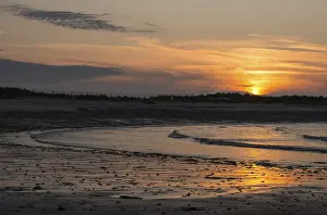 Atmospheric Light Prints: Sunset on a quiet beach with soft light on the waves