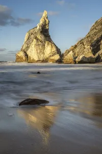 Sandy Ocean Beach Scenery Prints: Sunset on sandy beach with rocks