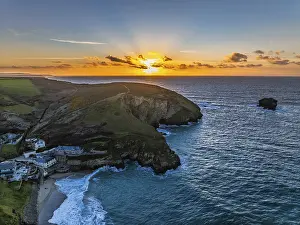Atmospheric Evening Sky Prints: Sunset over sea and cliffs from a drone