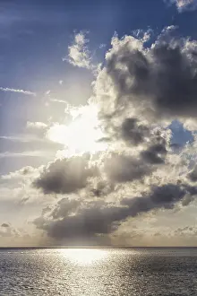 Sunset Over The Sea Prints: Sunset over the sea with the sun rays through the clouds