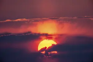 Deserted Sunset Prints: Sunset, sun behind clouds