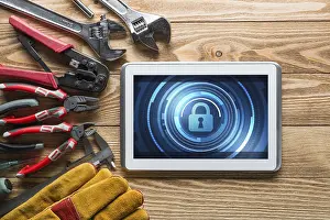 Tablet Pc Security Concept Prints: Tablet pc with security concept on screen and industrial tools around