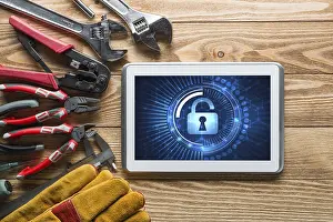 Tablet Pc Security Concept Prints: Tablet pc with security concept on screen and industrial tools around