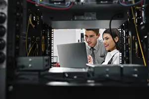 Healthcare Technology Prints: Team of technicians working together on servers at the data centre