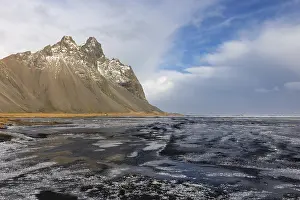 Mountainous Massif Landscape Prints: Teared water on lava sandy beach against mountain backdrop