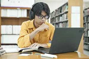 Education Concept Prints: Thoughtful Young Student Preparing for Class