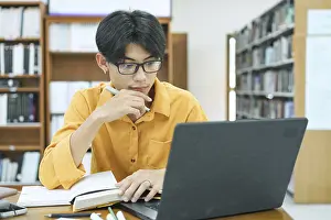 Thoughtful Student Prints: Thoughtful Young Student Preparing for Class