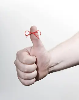 Symbolic Picture Studio Shot Prints: Thumbs up with a red string bow, memory