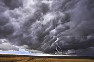 Thunderstorm Mood Photography Prints: The thundercloud and lightning above boundless plain in state of Idaho