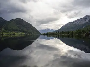 Stormy Atmosphere In Europe Prints: Thunderclouds are reflected in the lake