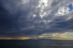 Tuscany Sunset Prints: Thunderclouds at sunset on the beach