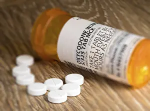 Deserted Wooden Table Scene Prints: Tiltshift effect of prescription bottle for Oxycodone tablets