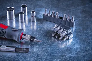 Handicraft Industry Tools Prints: Toolset of screwdriver with stainless replaceable bits and torx on scratched metallic background construction concept