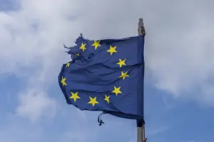 British National Colors Prints: A torn EU flag blows in the wind with a few clouds in the background