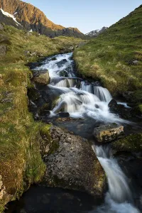Stornappstinden Summit View Prints: A torrent flows down the mountain