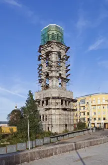 Exterior View Of A Sacral Building Prints: Tower monastery under construction over blue sky background in Samara